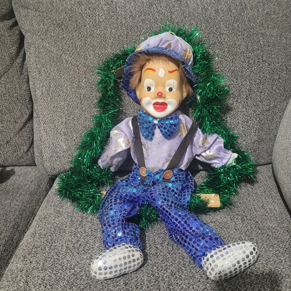 Porcelain clown on swing.